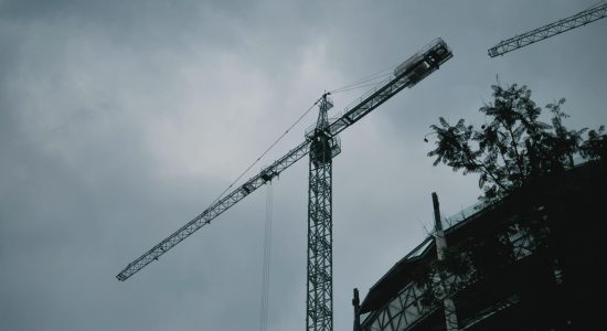 mixkit-construction-crane-with-an-airplane-flying-past-2010_20.jpeg